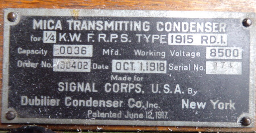 Dubilier mica transmitting condenser nameplate with Signal Corps order information.