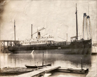 SS Cordova docked with lumber, 1912. Six-wire antenna visible.